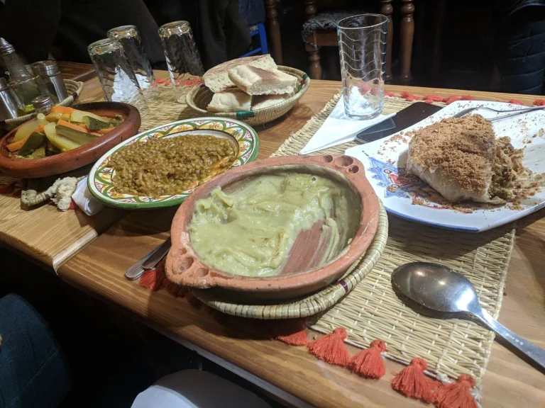 Table of traditional Moroccan dishes: couscous, tagine and salads